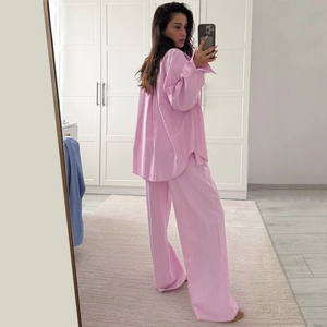 Detail of pink and white striped pajamas set showing breathable fabric and loose long-sleeve fit