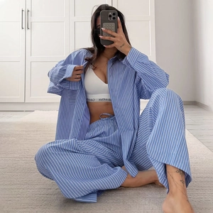 Detailed view of women's blue striped loungewear set featuring long sleeve shirt and pants