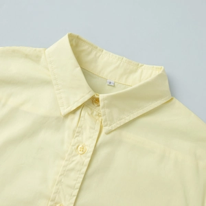 Detail of light yellow cotton shirt collar with small resin buttons and S size label