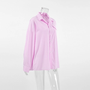 Detailed close-up of pink and white striped cotton shirt with button-down collar and chest pocket