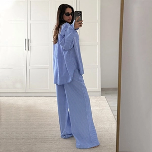 Detail view of blue and white striped lounge set with long-sleeve shirt and wide-leg pants