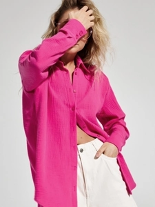 Detail of bright pink cotton crepe shirt showing the breathable wrinkled texture and buttons