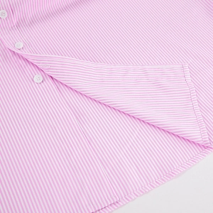 Close-up of pink striped cotton shirt showing white buttons and fine fabric texture