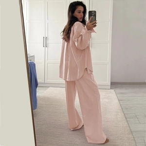 Detail view of pink and white striped pajamas set with long sleeves and wide-leg pants