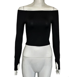 Detail of off-shoulder black crop top featuring thumb hole cuffs and ribbed stretchy fabric