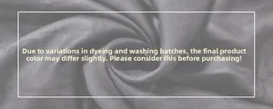 Detail of dark gray fabric texture showing silky smooth finish and layered ruffles