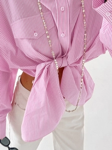 Detail of pink and white striped cotton shirt with front knot and chest pockets