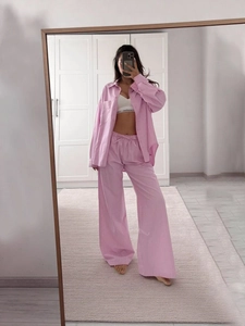 Women's pink striped loungewear set with loose long-sleeve shirt and wide-leg trousers