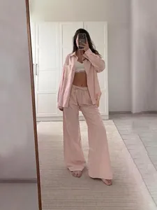 Pink and white striped two-piece loungewear set with long sleeve shirt and wide-leg pants