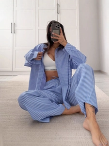 Women's two-piece blue striped loungewear set with long sleeve shirt and wide-leg pants