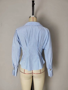 Blue striped long sleeve shirt with pleated waist design and wide cuffs on mannequin