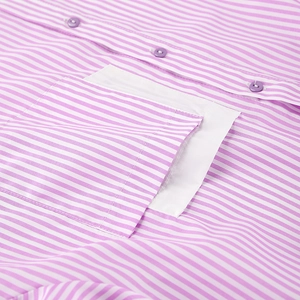Macro detail of pink and white striped shirt featuring purple button and chest pocket