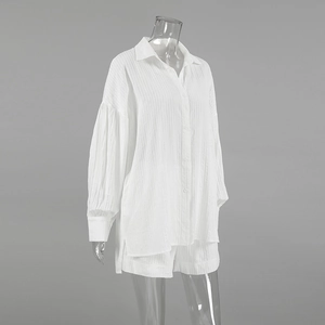 Detailed macro view of white cotton jacquard fabric with vertical striped texture and buttons