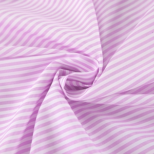 Detailed macro view of pink and white striped cotton fabric texture and soft drape