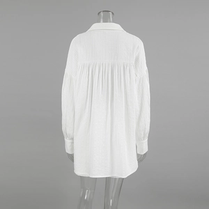 Detail of white cotton shirt back showing vertical texture and fine pleats design