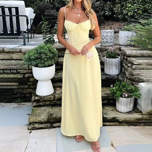 Detail of light yellow maxi dress showing thin straps and drawstring ruched bodice textures