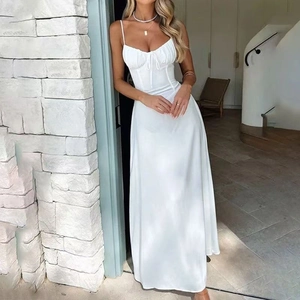 Detail of elegant white high-waist maxi dress with thin straps and pleated bodice