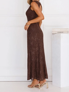 Detail of brown lace maxi dress showing intricate hollow-out patterns and subtle sequins