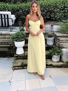 Elegant pale yellow spaghetti strap midi dress with a waist tie and A-line silhouette