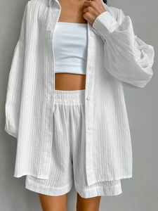 Close-up of white cotton jacquard fabric texture on puff sleeve shirt and shorts set