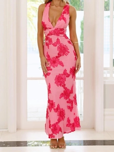 Detailed view of pink 3D floral appliques and embroidery on a backless maxi dress