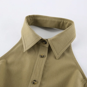 Detail of khaki halter top collar featuring pointed shirt lapel and tortoise buttons