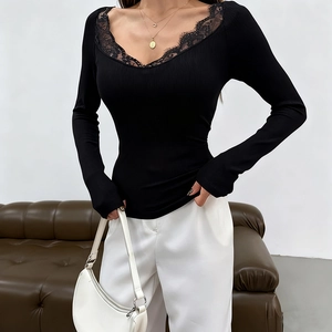 Detail of elegant V-neckline with delicate black lace trim and ribbed knit texture