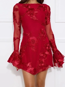 Detail of red mesh mini dress featuring 3D floral embroidery and flared bell sleeves