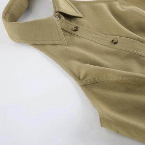 Detailed close-up of khaki sleeveless polo shirt collar and wooden buttons texture