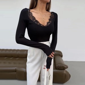Detailed view of women black long sleeve top with elegant eyelash lace V-neckline