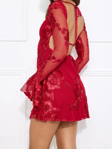 Close-up of red 3D floral embroidery and lace-up back detail on backless mini dress