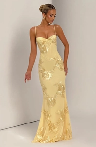 Detail of light yellow slim fit dress featuring exquisite gold floral embroidery and straps