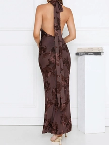 Detail view showing the open back and 3D floral texture of a brown halter maxi dress
