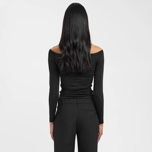 Rear view of a slim-fit black off-shoulder long sleeve top with textured fabric details