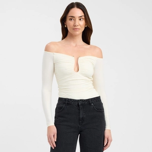 Close-up of cream off-shoulder top featuring stylish front ruching and a teardrop neckline