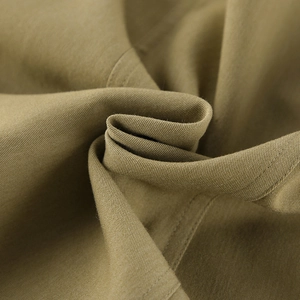 Detailed macro view of khaki twill fabric texture and durable stitching for summer tops