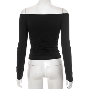 Detail view of the black off-the-shoulder long sleeve top showing pleated back waistline