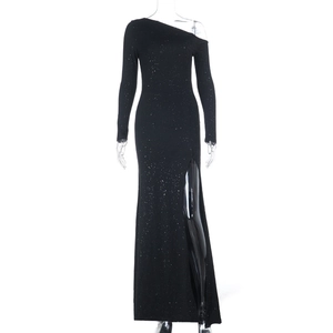 Detail of black one-shoulder evening gown featuring silver glitter and high side slit