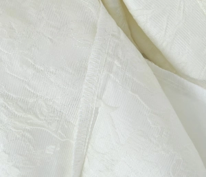 Gros plan détaillé du tissu jacquard blanc avec des coutures overlock de haute qualité