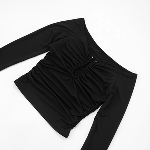 Detail of black long-sleeve top featuring ruched hollow out design and metal beads