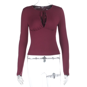 Detail of burgundy slim fit top featuring keyhole cutout with tie and pleated bust