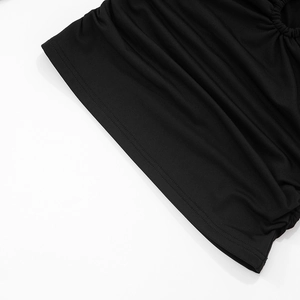Macro detail of the black fabric featuring neat stitching and elegant ruched texture design