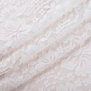 Nahaufnahme von elegantem floralem Spitzenstoff mit Stickerei auf weißem Abendkleid