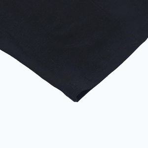 Detailed macro view of the soft ribbed knit texture and hem stitching on long sleeve top