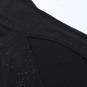 Detail of black fabric with silver sequins and a neat side slit on an A-line dress