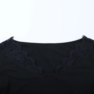 Close-up of elegant V-neckline with delicate black floral lace trimming on top