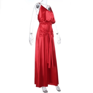 Detailed view of dark red satin dress with waist knot detail and glossy fabric texture