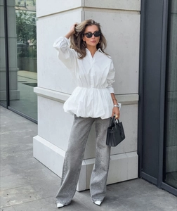 Chic women's white peplum waist shirt styled with sparkling grey wide-leg sequined trousers