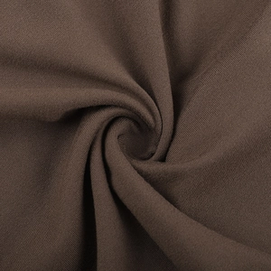 Macro shot of dark brown high-density knitted fabric texture and fine fiber structure