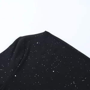 Detailed macro view of black fabric featuring sparkling silver glitter and sequins